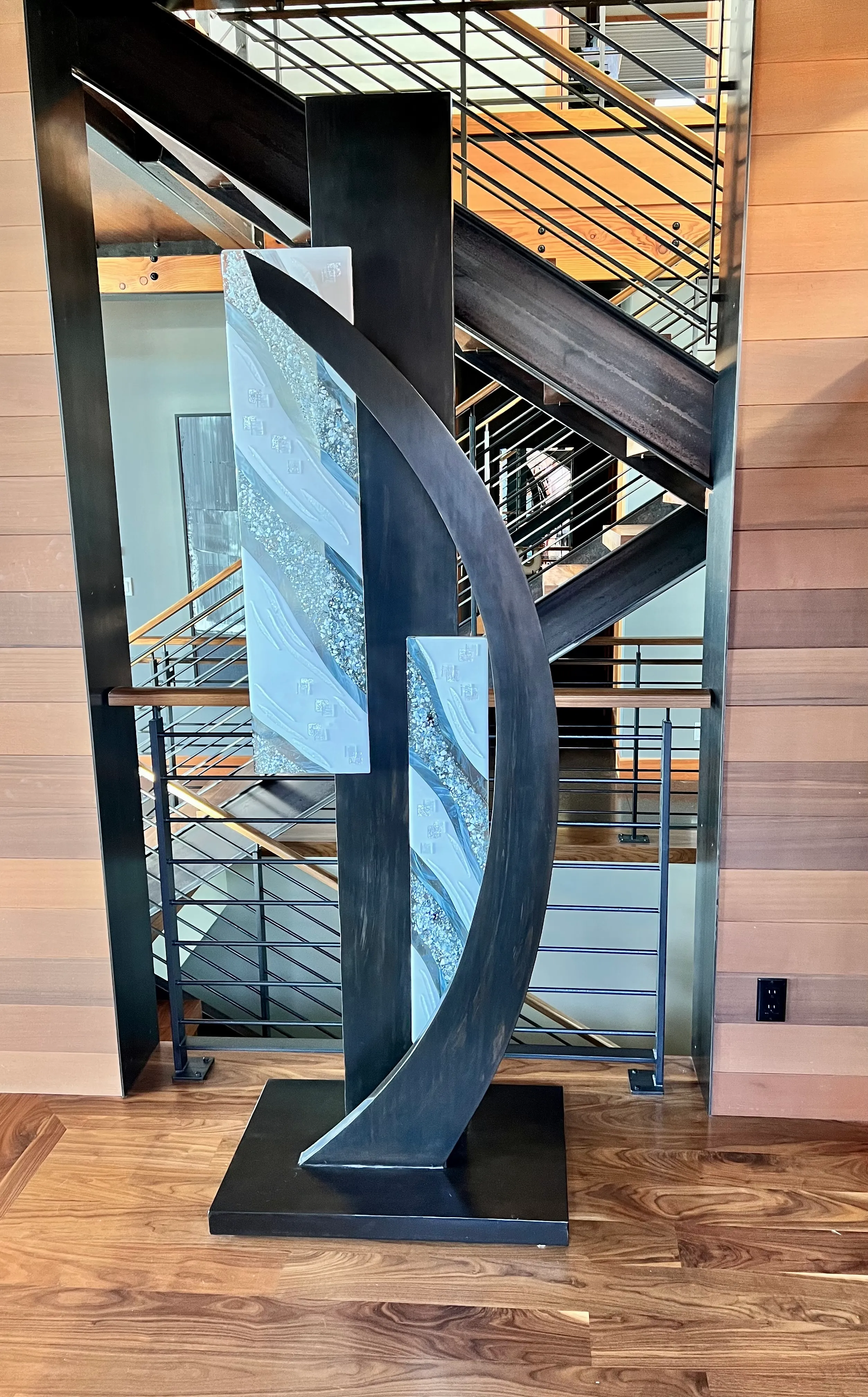 Freestanding sculpture combining welded metal and fused glass