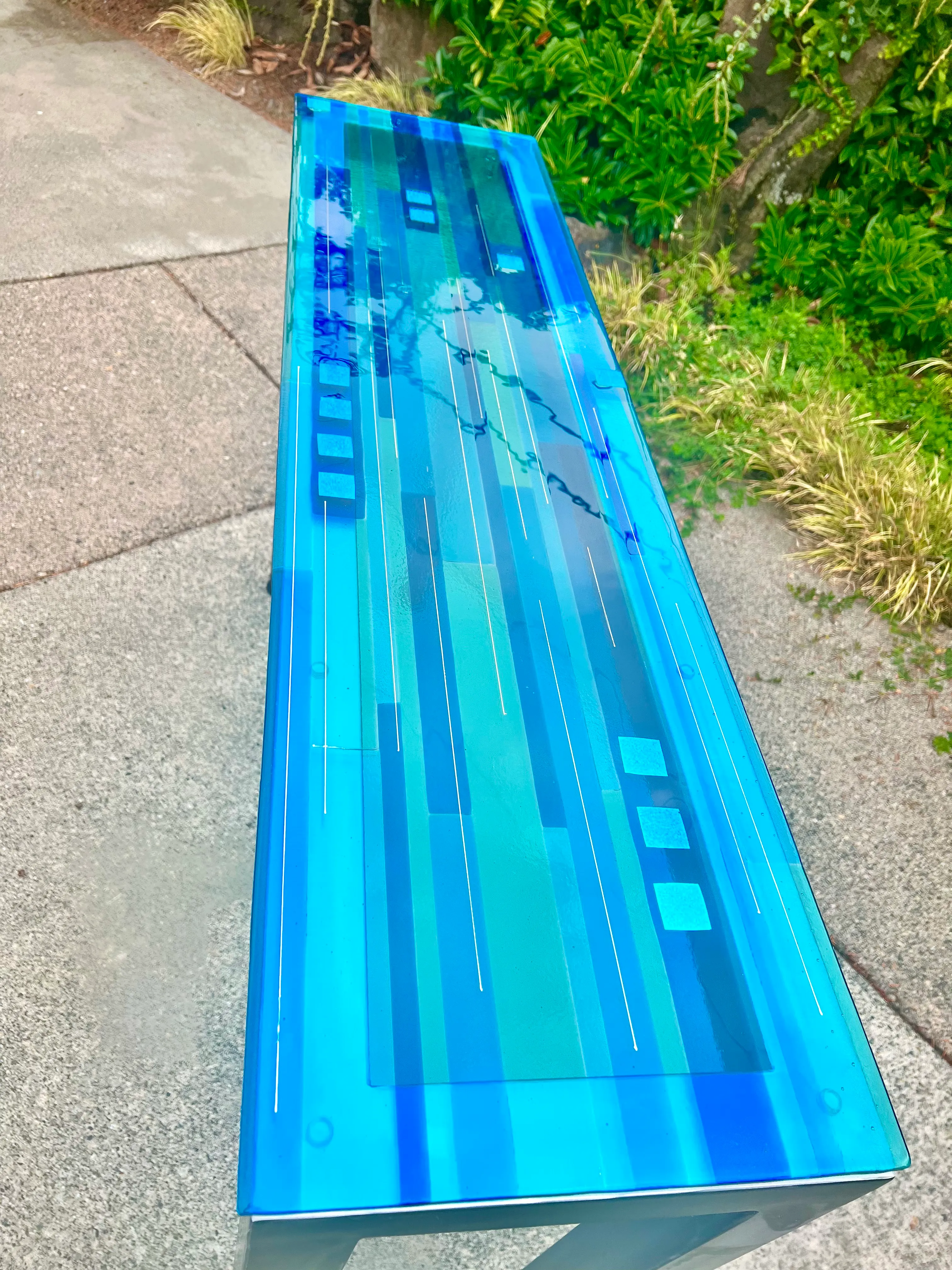 Glass table top with fused artistic design