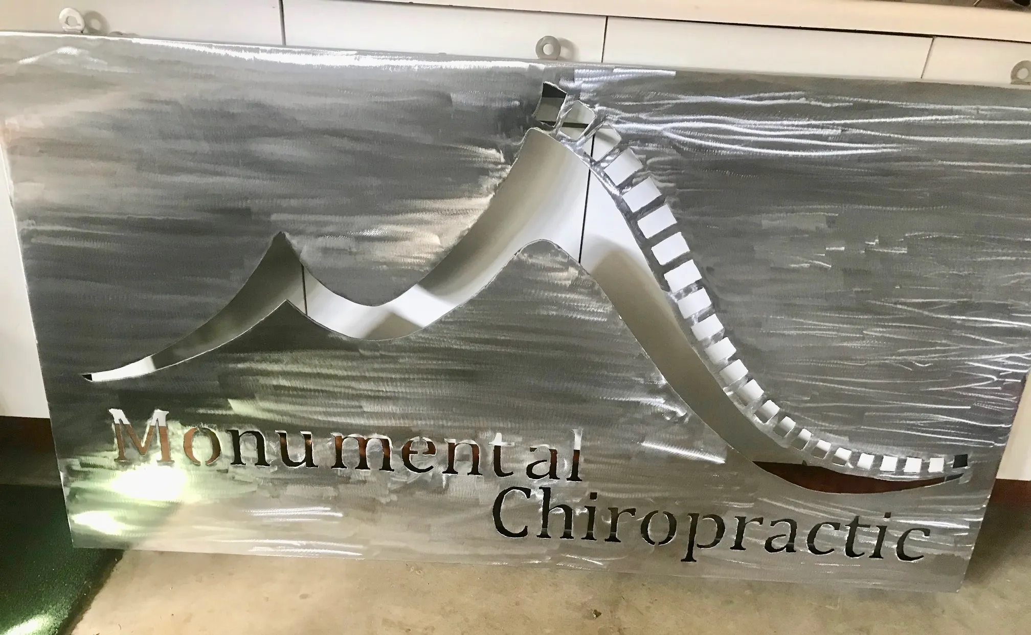 Metal signage with artistic scrollwork