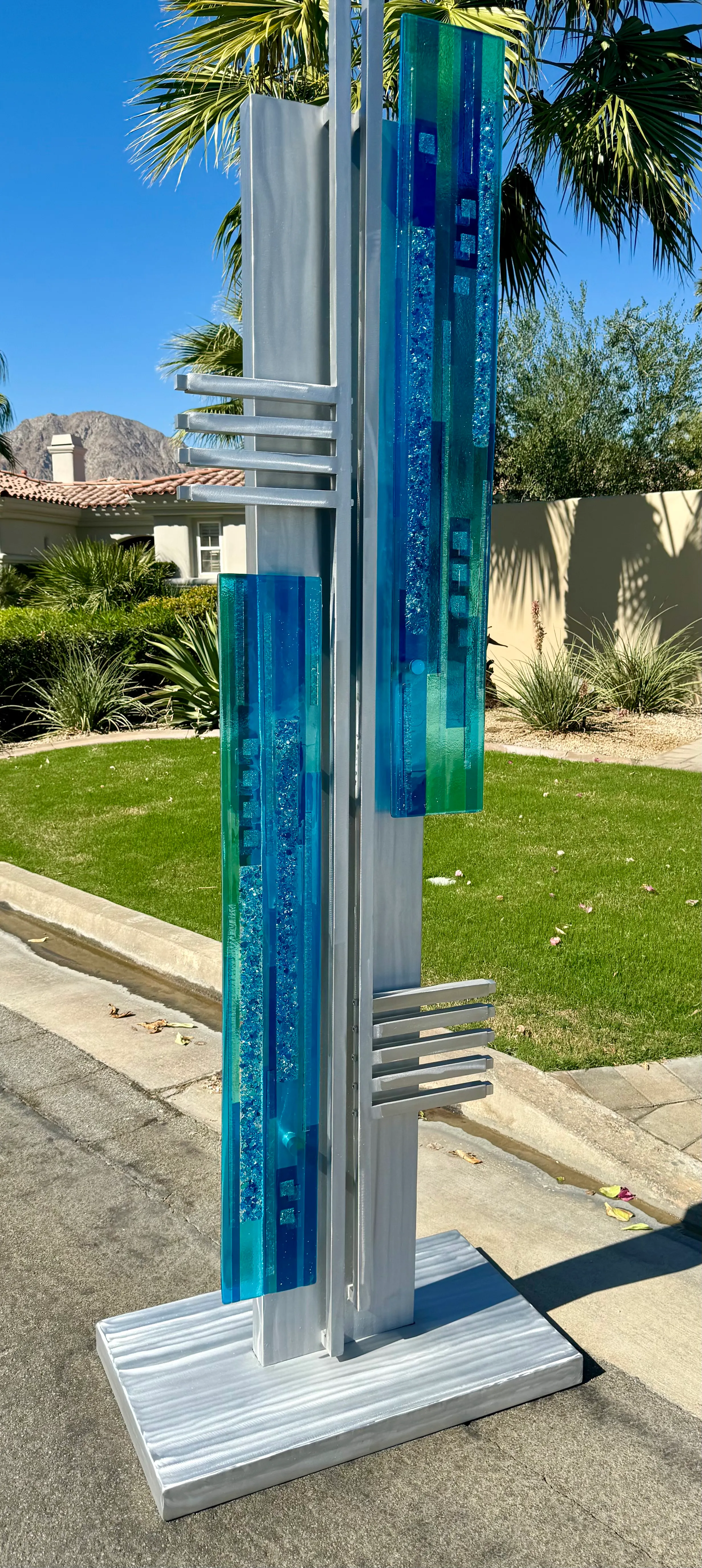 Steel and glass sculpture with flowing organic form