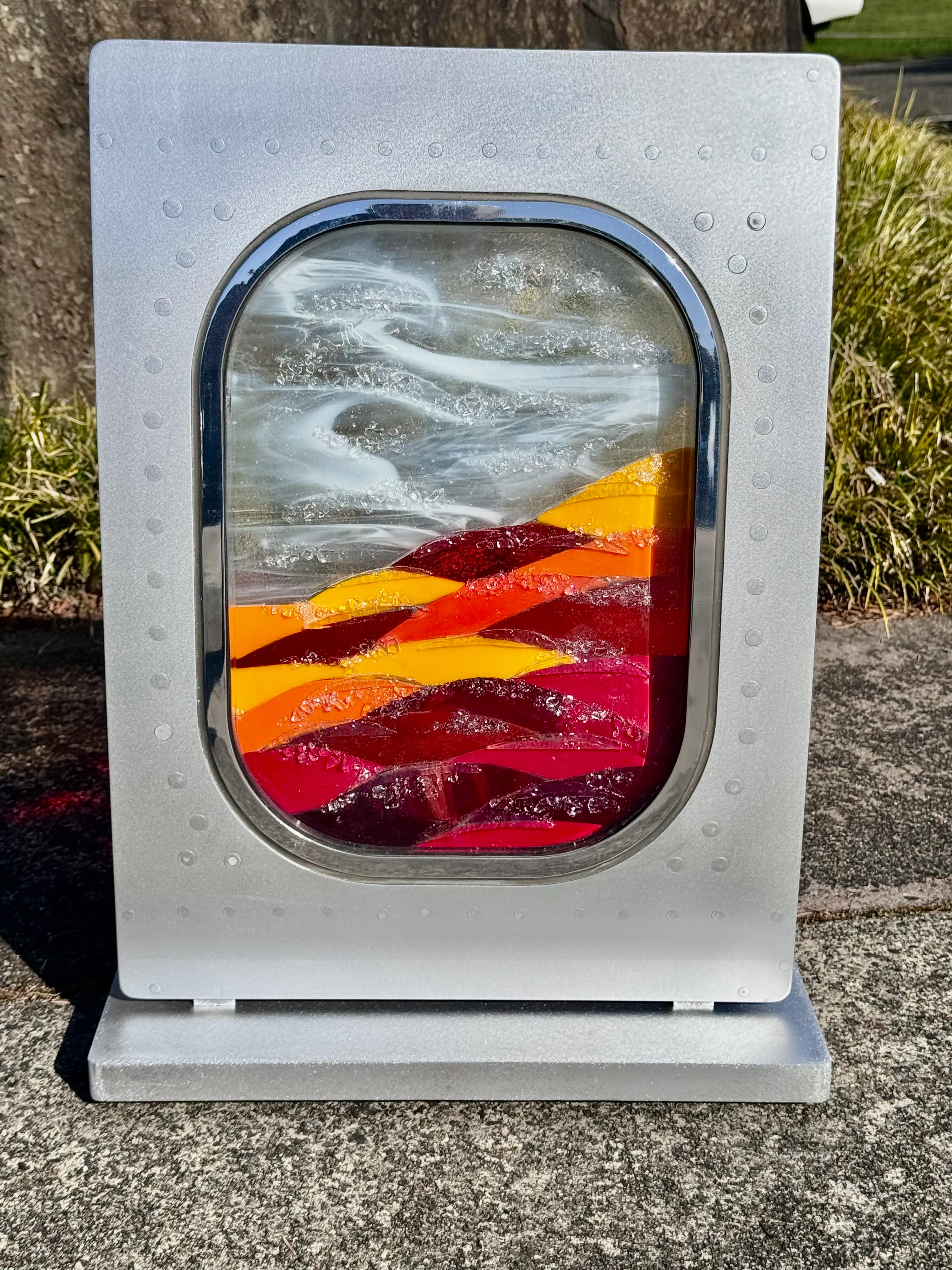 Freestanding metal and glass sculpture with dynamic composition