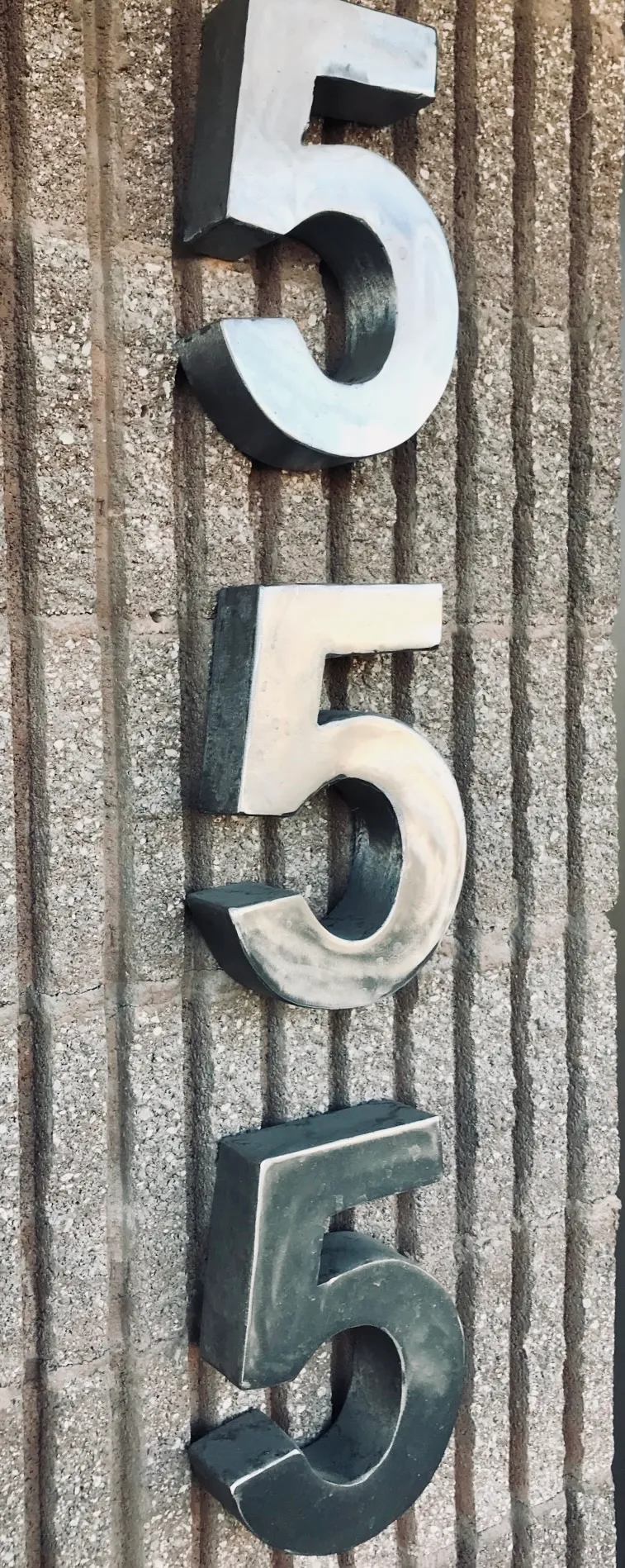 Welded metal sign with ornamental detail