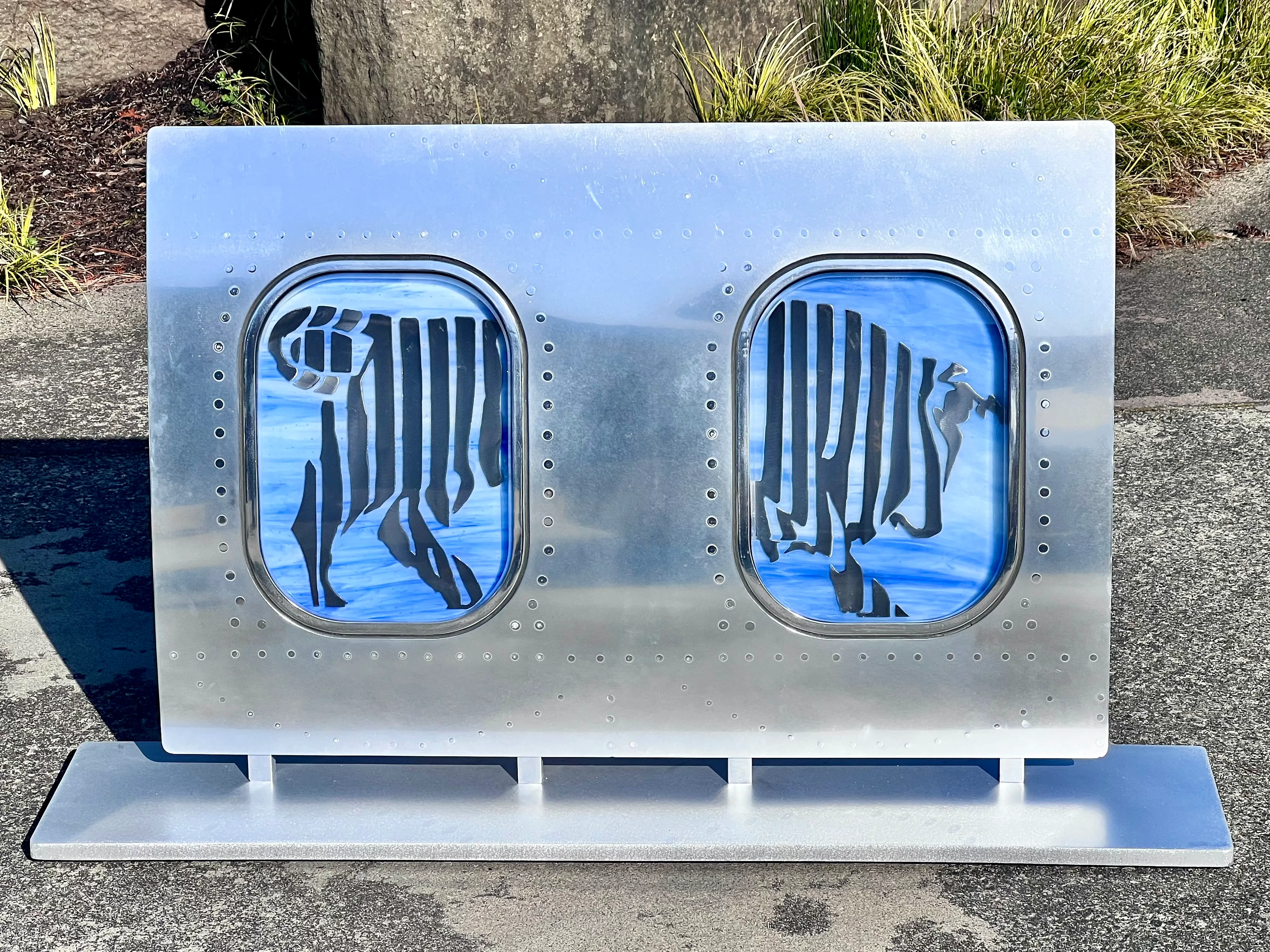 Collaborative sculpture combining forged steel and fused glass