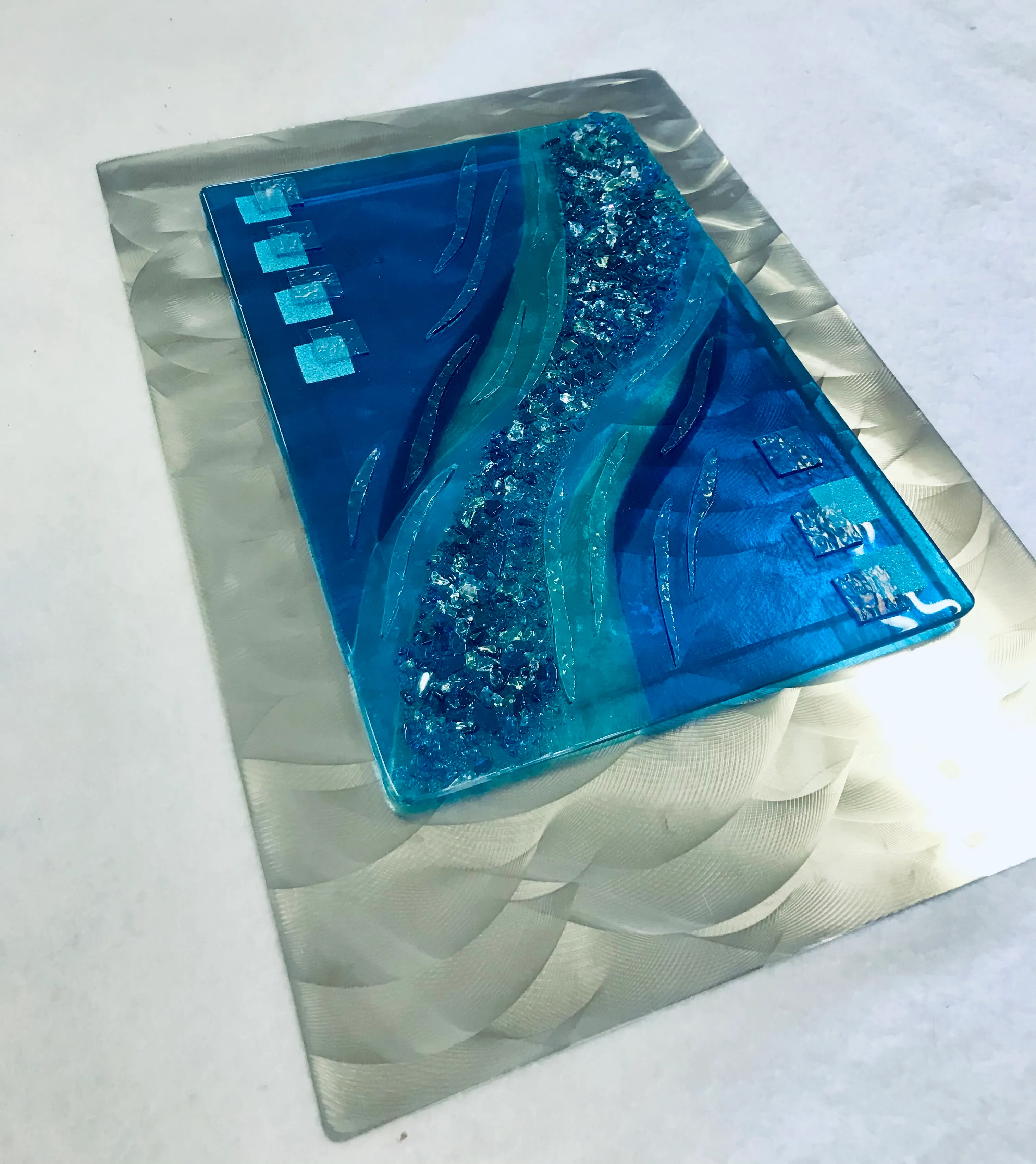 Glass art piece with sweeping curves and depth